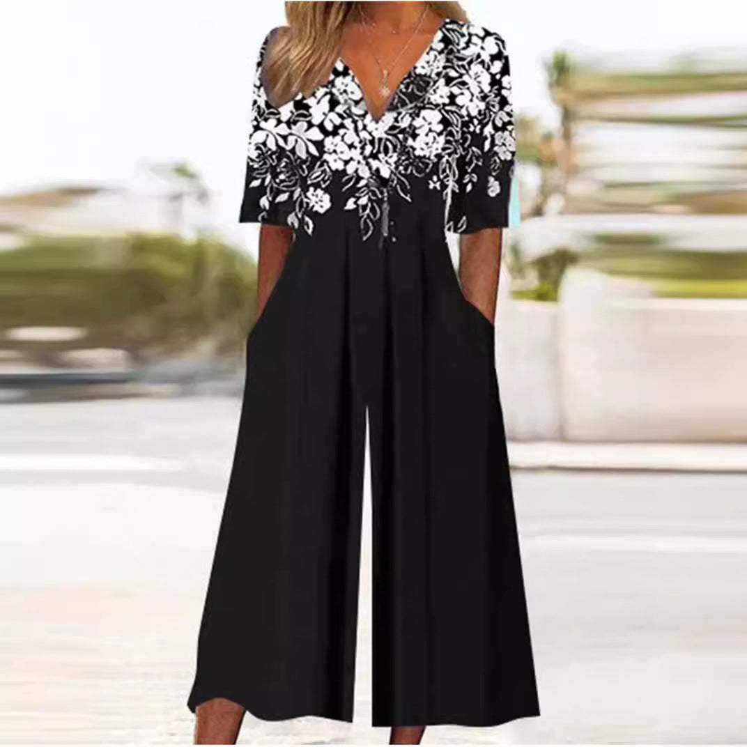 White floral V-neck wide-leg jumpsuit with elbow sleeves. Bohemian women's palazzo for elegant summer outfits & comfort.