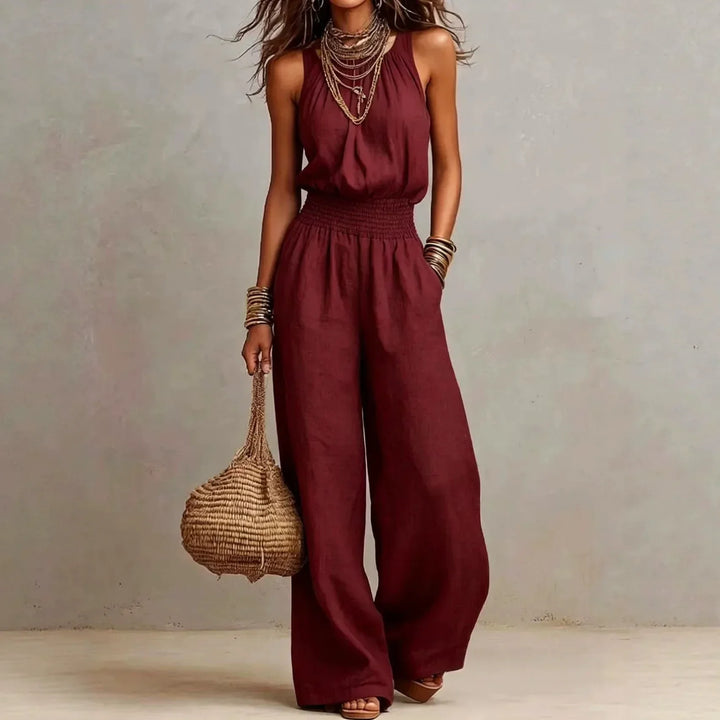 Elegant women's halter neck wide leg jumpsuit, featuring a flowing silhouette for chic summer resort wear.