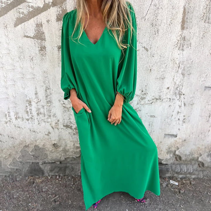 Stylish women's summer maxi dress featuring a flowy design, elegant balloon sleeves, V-neck, and essential pockets.