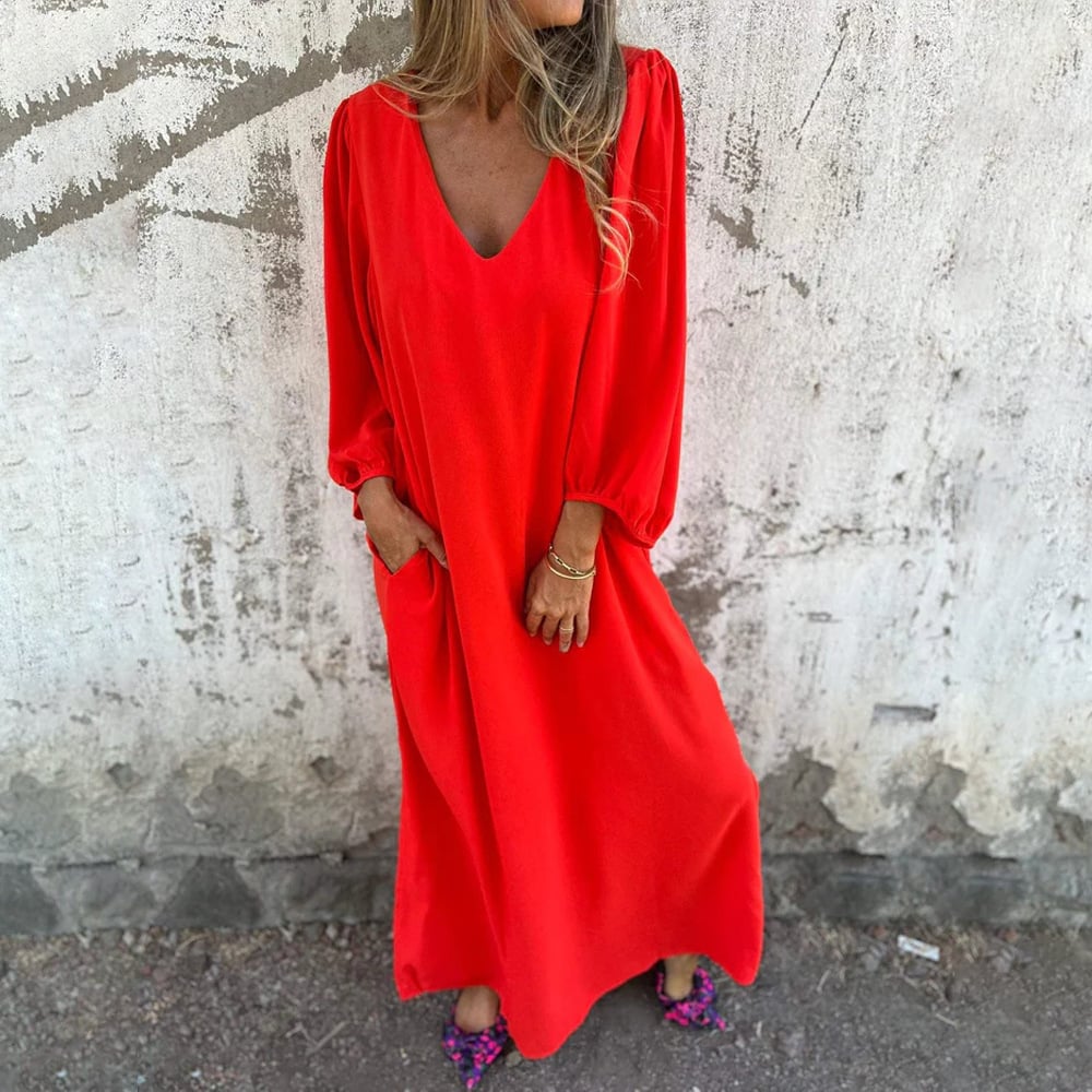 Comfortable women's long flowy summer dress, featuring a stylish V-neck and practical side pockets.