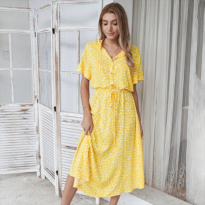 Beautiful women's flowy midi dress with a charming summer print. Casual yet elegant for warm weather fashion.