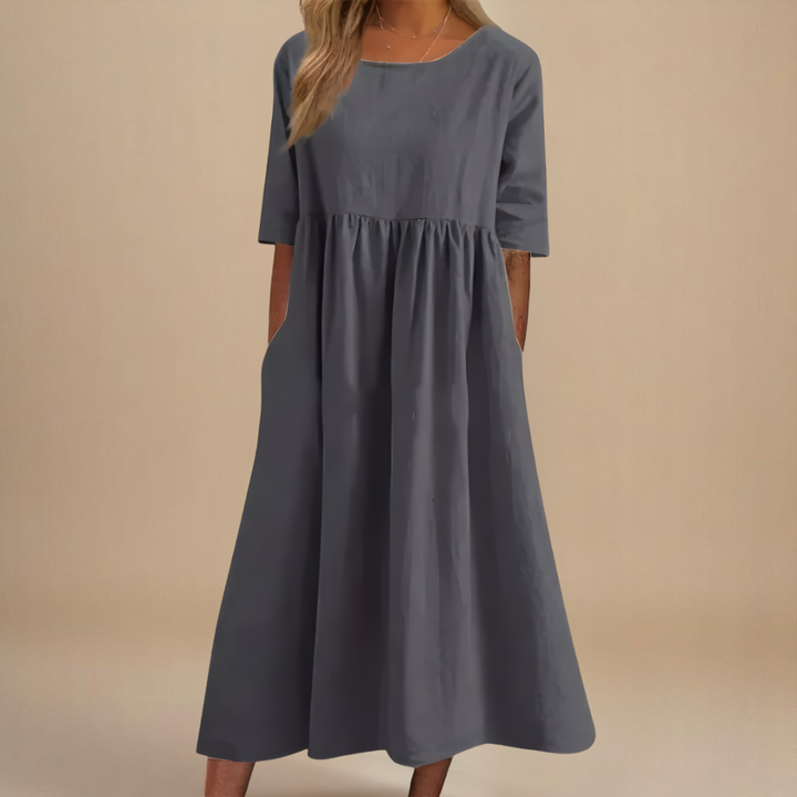 Elegant women's empire waist midi dress with half sleeves, scoop neck, and functional side pockets.