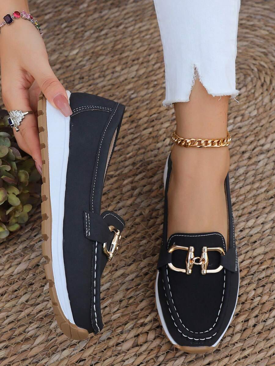 Comfortable women's gold chain flatform loafers worn on foot, perfect for everyday comfort and casual fashion.