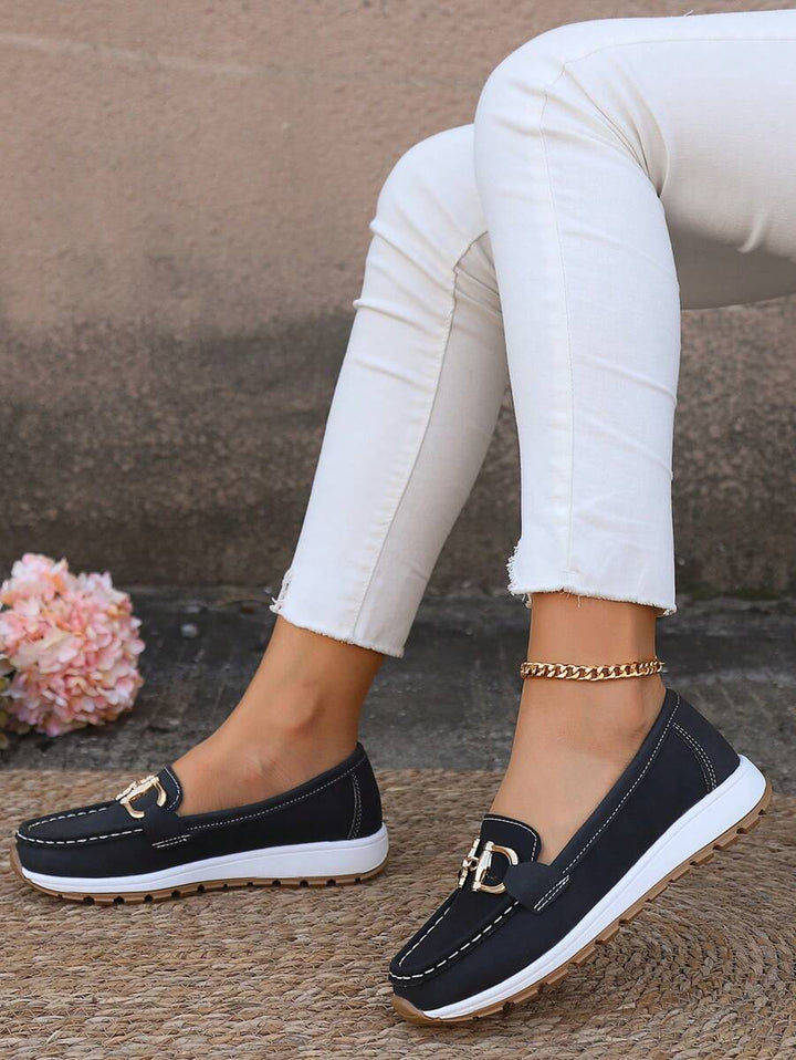 Flatform sole of women's loafers with gold chain detail, providing height and comfort for versatile everyday wear.