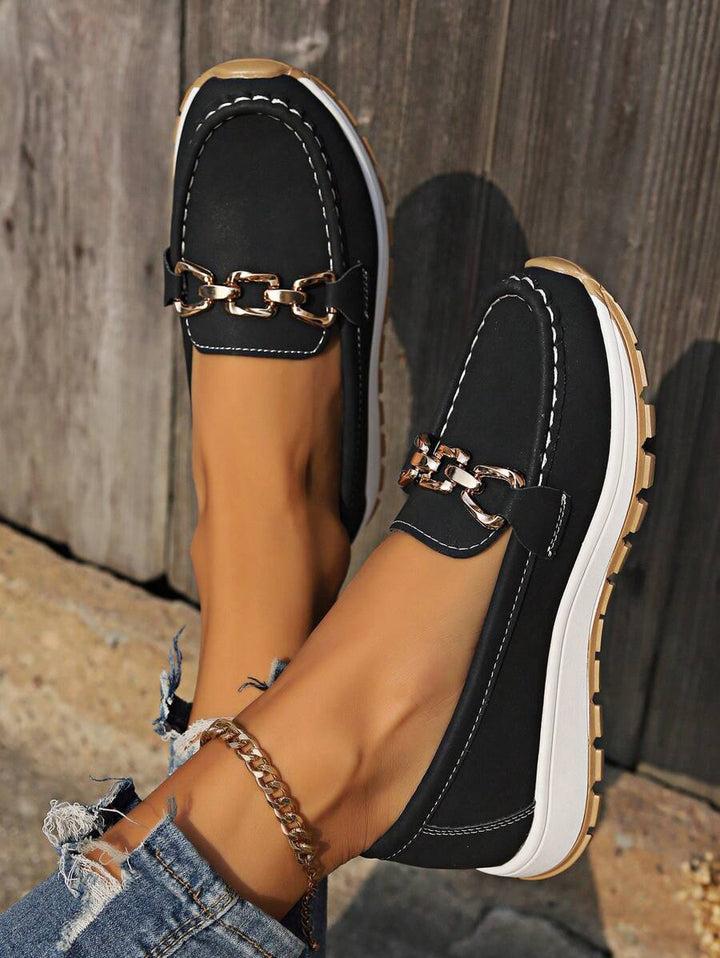 Women's slip-on loafers featuring striking gold horsebit detail. Elegant and comfortable everyday footwear.