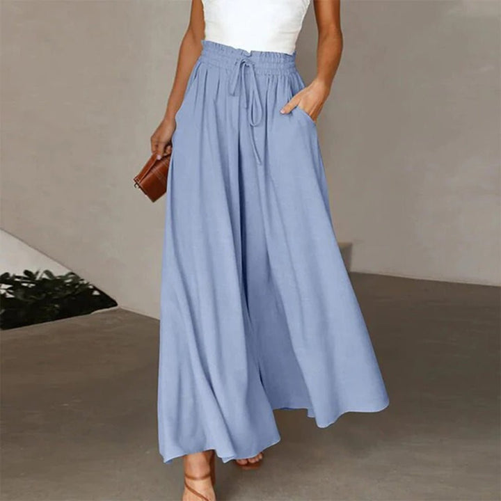 Versatile women's high waist wide leg pants. Features drawstring, pockets, and a flowing design for day to night wear.