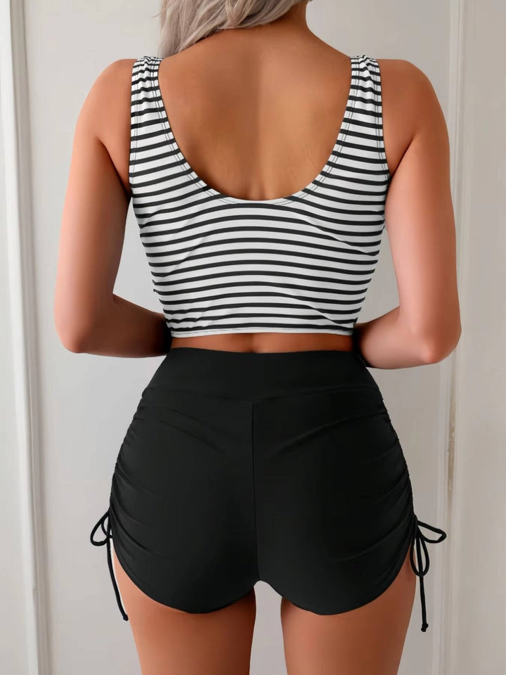 Cross-wrap tankini top and high-waisted bottom, a women's swimsuit designed for comfort and style.