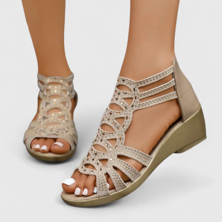 Women's comfortable open-toe wedge sandals with stylish laser-cut details & supportive orthopedic design.