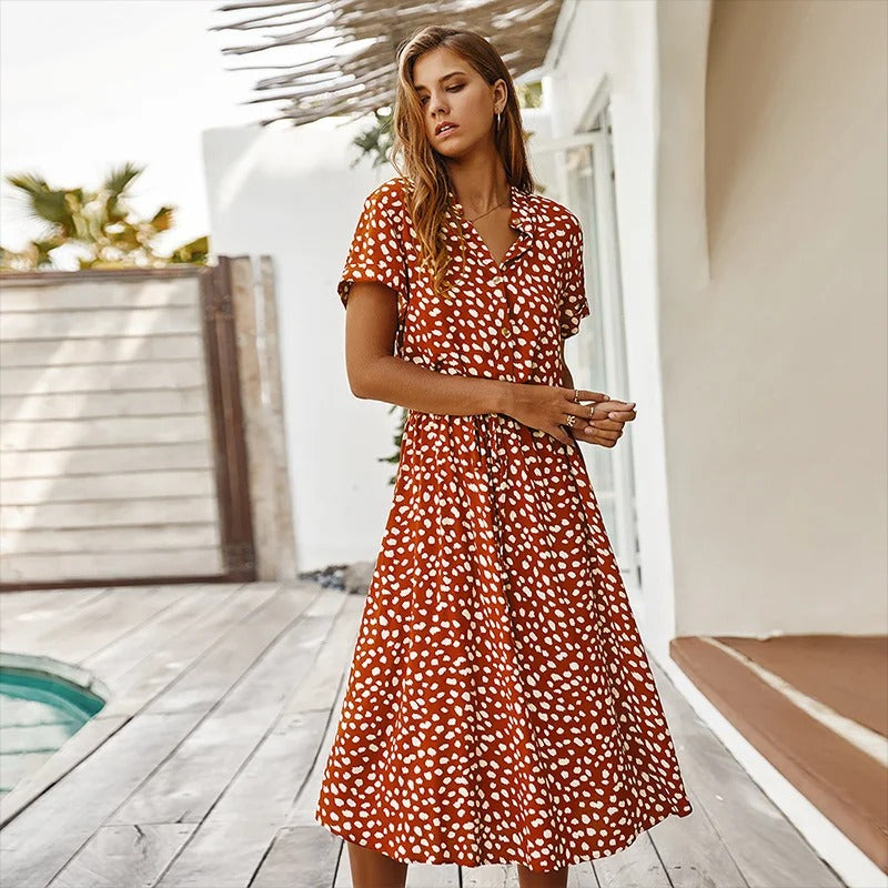 Detail shot: Women's leopard print V-neck midi dress, showcasing button-down front, belt & soft fabric texture.