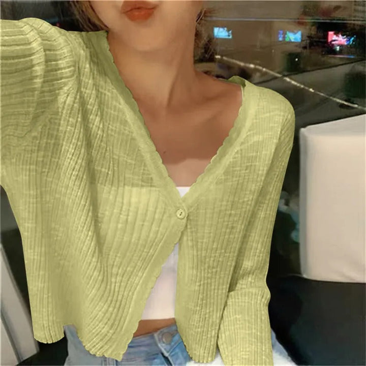 Model wearing a women's lightweight cropped cardigan, styled casually for everyday fashion. Button front.