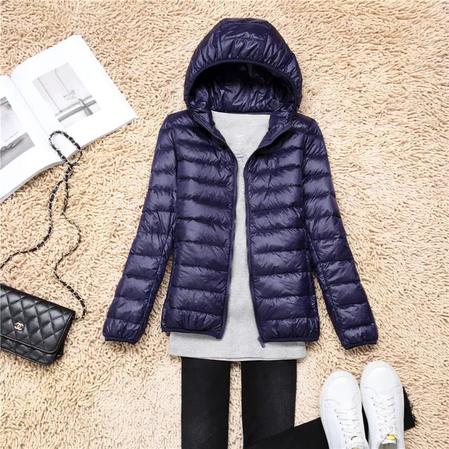 Hooded packable puffer jacket for women. Lightweight outerwear for outdoor activities.