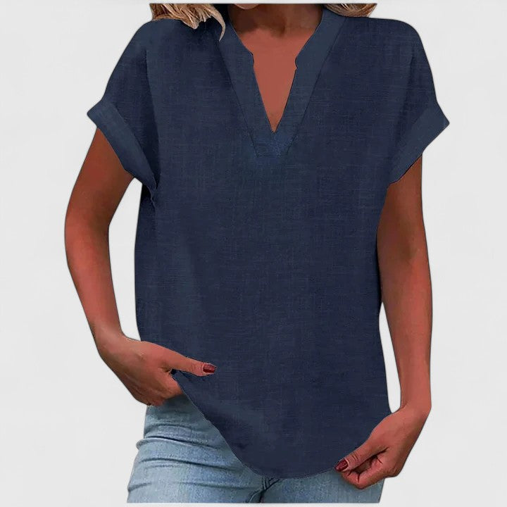 Versatile women's V-neck top, loose fit, cap sleeves, curved hem, great for relaxed fashion.
