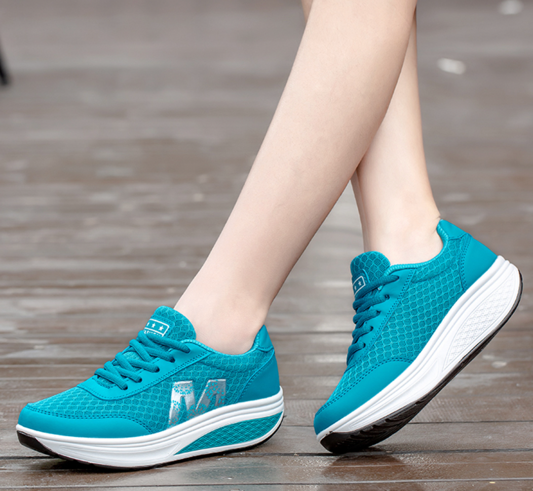 Woman walking in orthopedic corrective sneakers, offering arch support & all-day comfort.