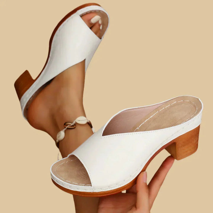 Supportive thick block heel on women's orthopedic sandal, ensuring stable comfort for walking.