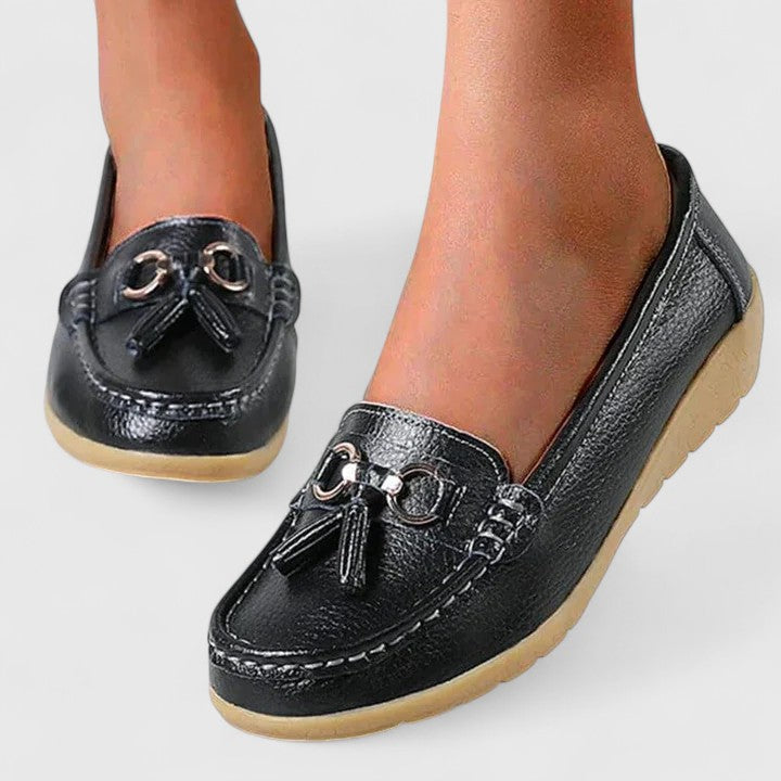 Black women's orthopedic loafers, providing cushioned support for all-day comfort & style.