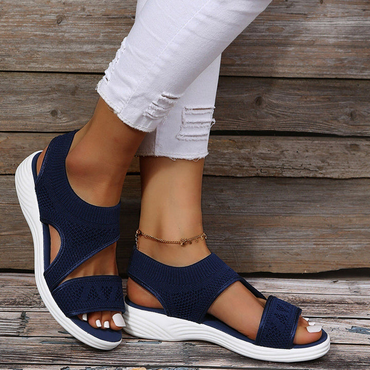 Comfortable women's wedge sandals with orthopedic arch support. Stylish open-toe design for daily wear.
