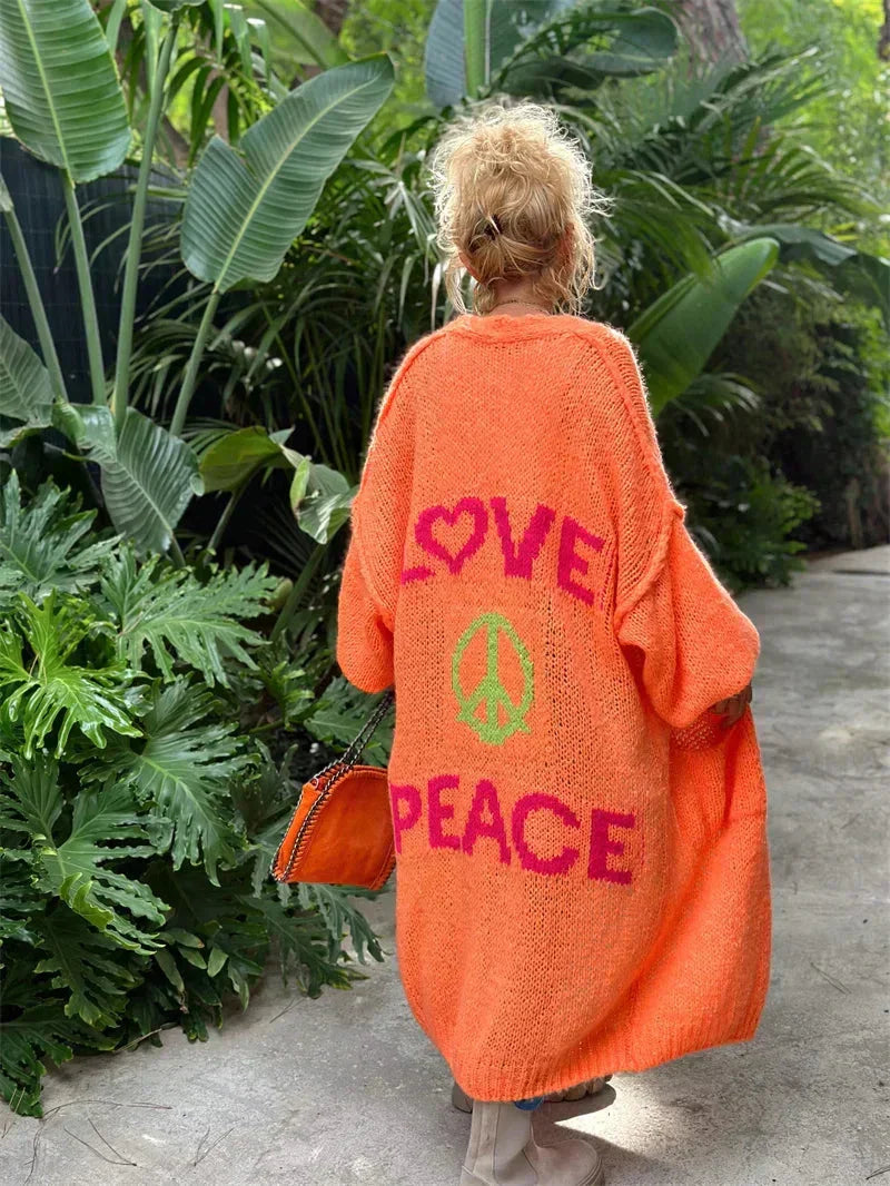 Bohemian style women's long oversized knit cardigan, featuring 'Love Peace' message & peace symbol.