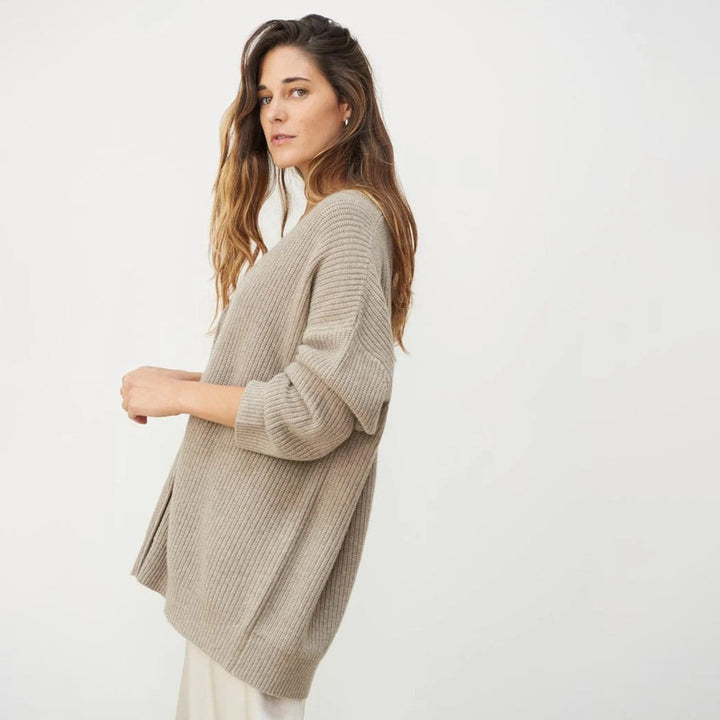 Buttoned-up women's oversized V-neck cardigan, ideal for a warm, casual everyday look.