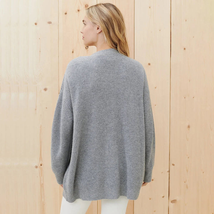 Soft knit women's oversized button-up cardigan, perfect for cozy casual fall and winter fashion.