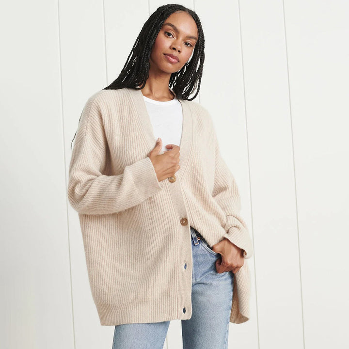 Front view of a women's oversized button-up V-neck cardigan, essential for winter fashion.
