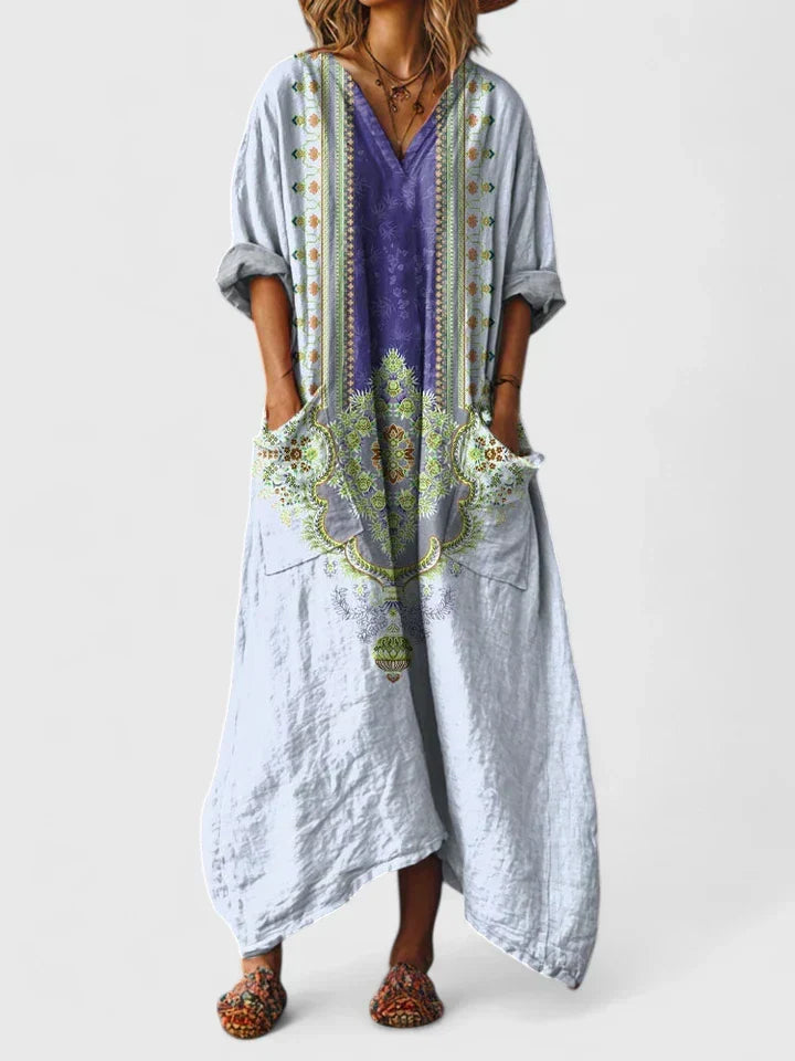 Elegant women's oversized paisley boho maxi dress, deep V-neck, bohemian style, with functional side pockets.