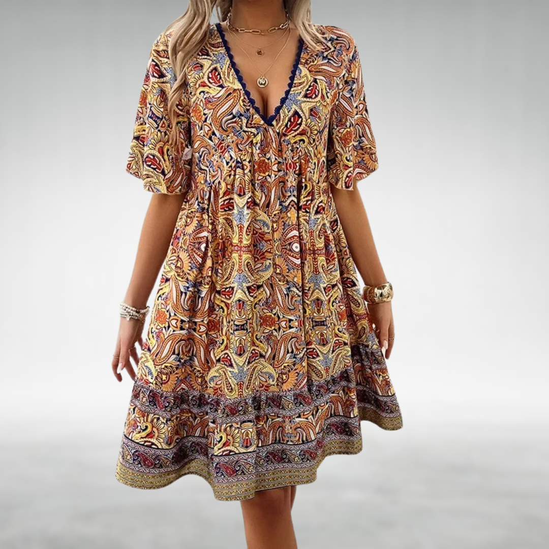 Women's paisley boho mini dress, V-neck, lace trim details, and a playful ruffle hem. Stylish summer fashion.
