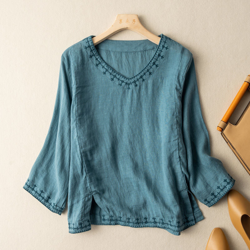 Stylish women's V-neck blouse with intricate pattern & short sleeves. Elegant yet casual top for summer fashion.