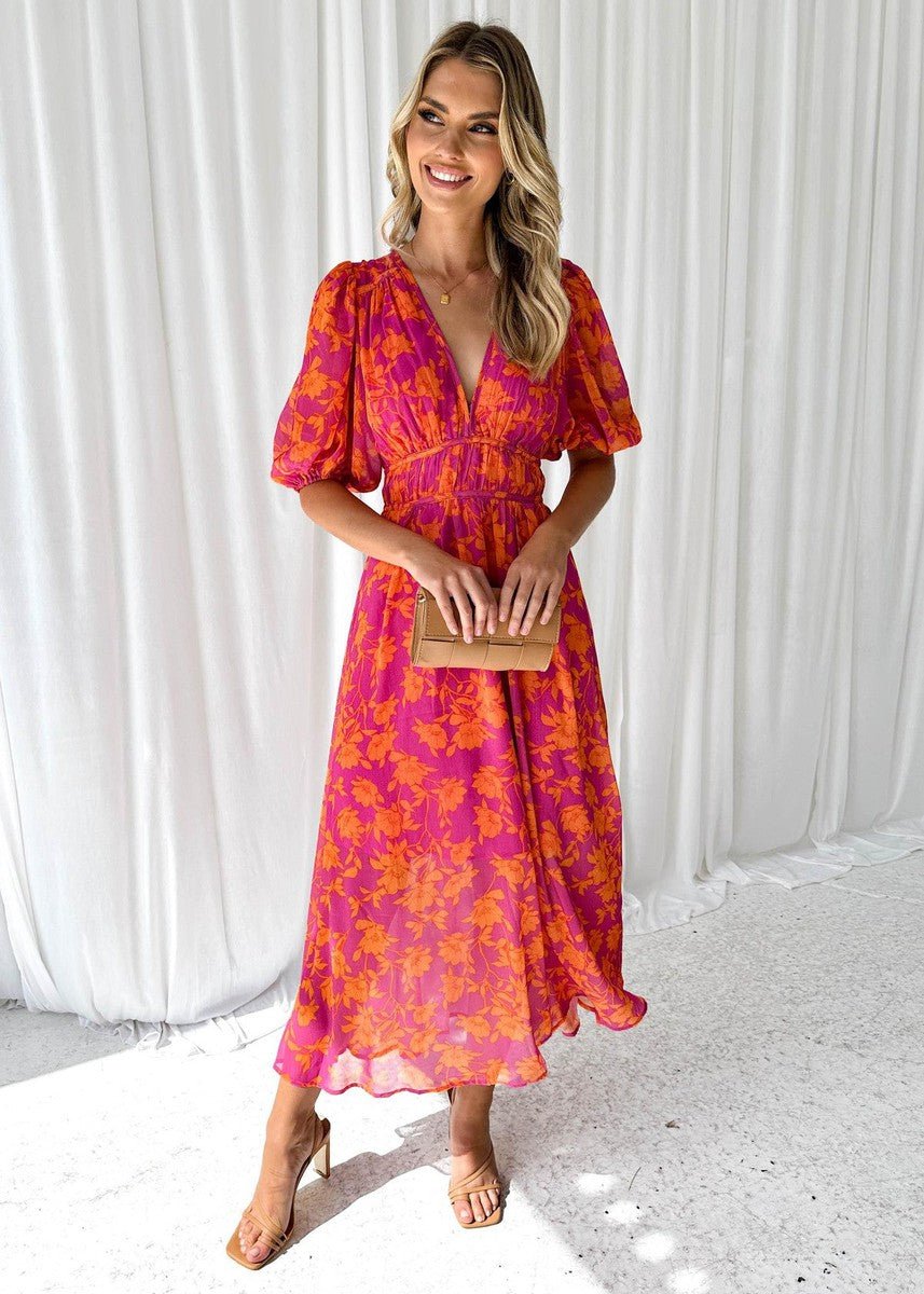 Women's pink-orange floral maxi dress with V-neck, puff short sleeves, and flowing silhouette. Perfect for summer.
