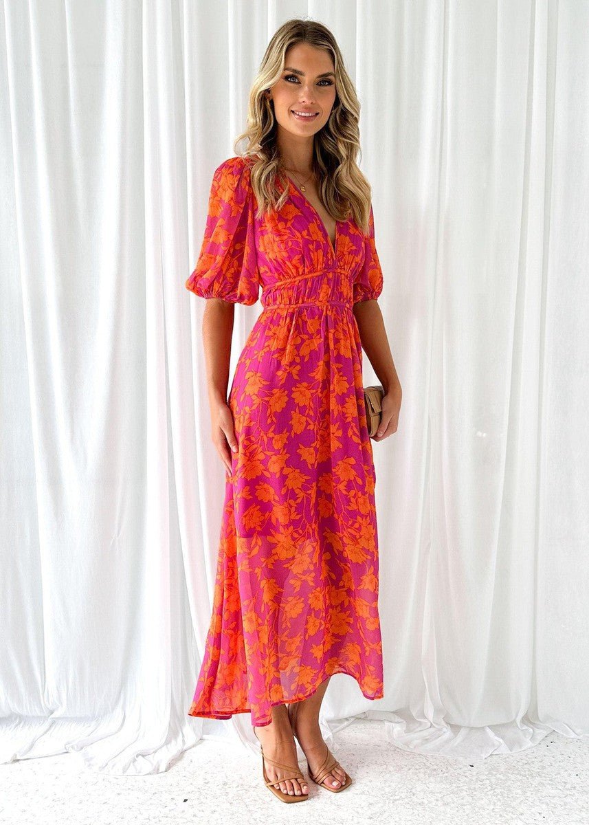 Bohemian pink-orange floral V-neck maxi dress with puff short sleeves. Ideal flowing summer vacation or brunch outfit.