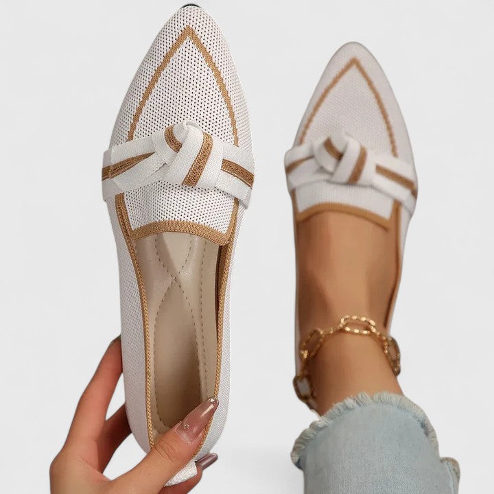 Women's pointed-toe flat loafers with knot-front detail, offering versatile effortless style.