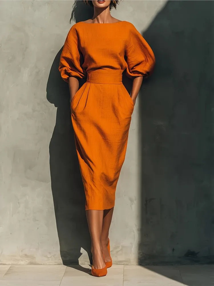 Women's puff sleeve midi dress with practical pockets, round neck, perfect for versatile everyday wear.