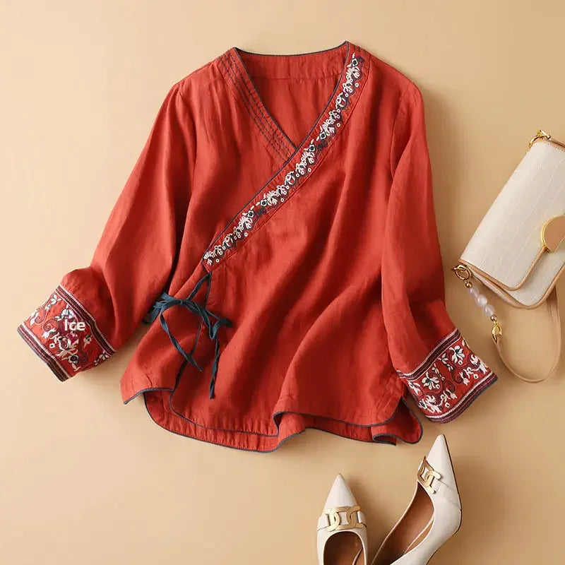Women's patterned V-neck blouse, relaxed fit, sophisticated embroidery.