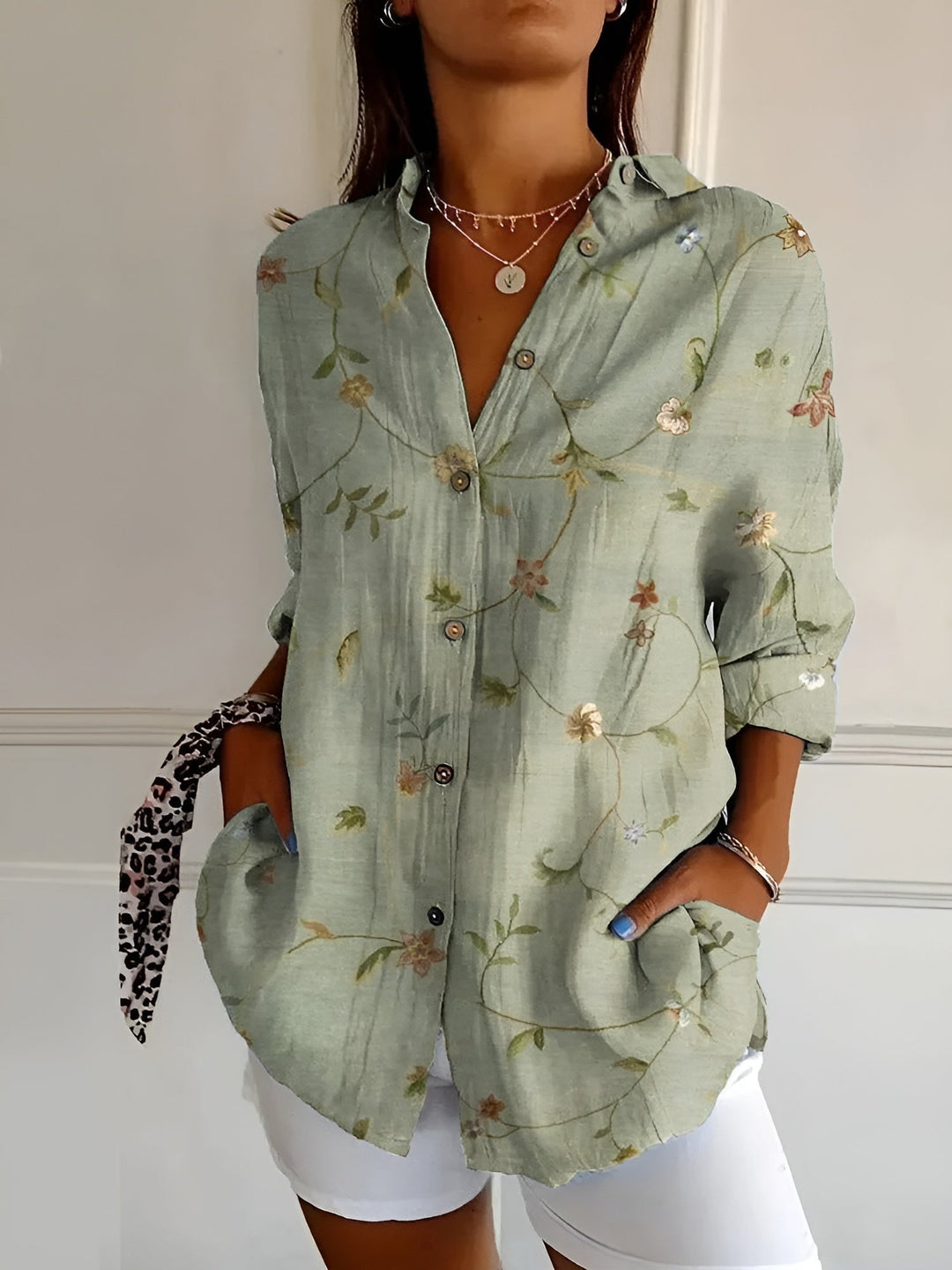 Women's relaxed fit button-down blouse with a stylish v-neck and comfortable long sleeves for everyday wear.