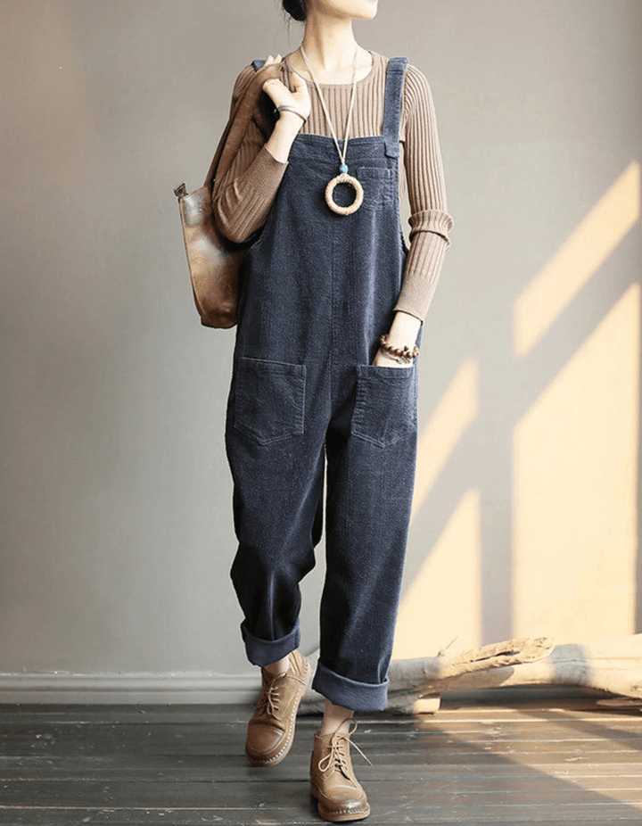 Women's vintage-style corduroy dungaree jumpsuit, relaxed wide-leg fit, adjustable straps, & patch pockets for fall.