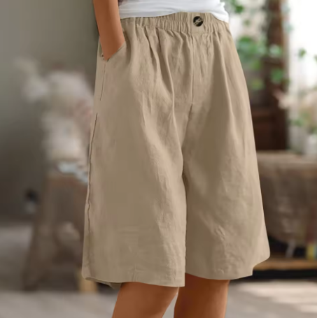 Front view of women's relaxed fit high-waisted Bermuda shorts. Casual summer comfort with an elastic waist.