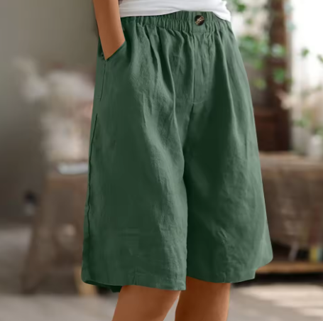 Back view of comfortable women's high-waisted Bermuda shorts. Relaxed fit, elastic waist for casual summer everyday wear.