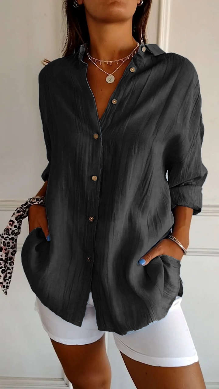 White women's oversized long sleeve button-up shirt, a relaxed fit casual blouse.