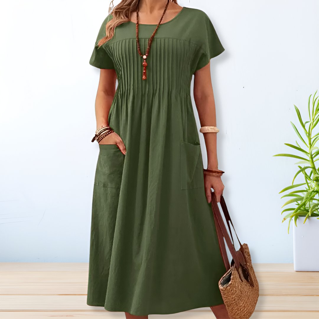 Women's relaxed fit midi dress with practical side pockets, short sleeves, and a comfortable, casual design for everyday summer style.