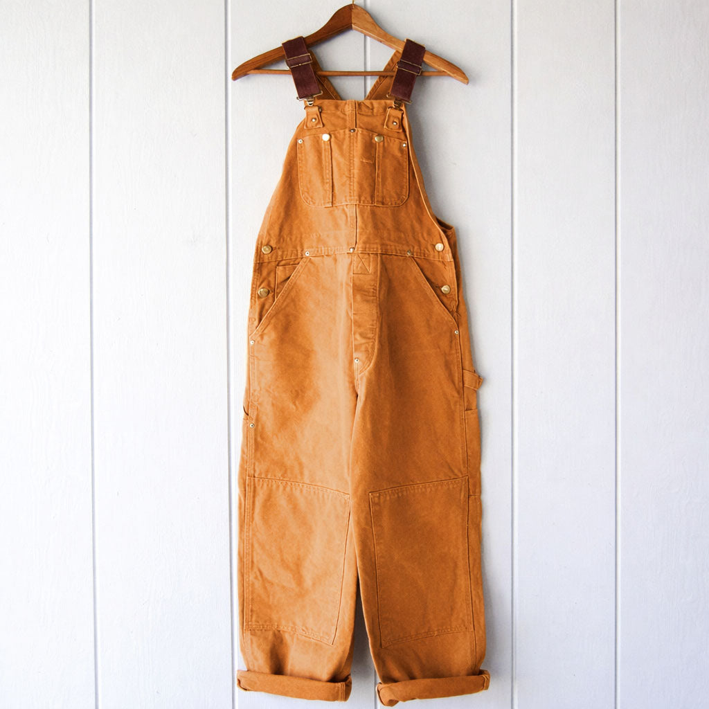 Women's relaxed fit sleeveless overalls with adjustable straps, perfect for casual everyday comfort and style.