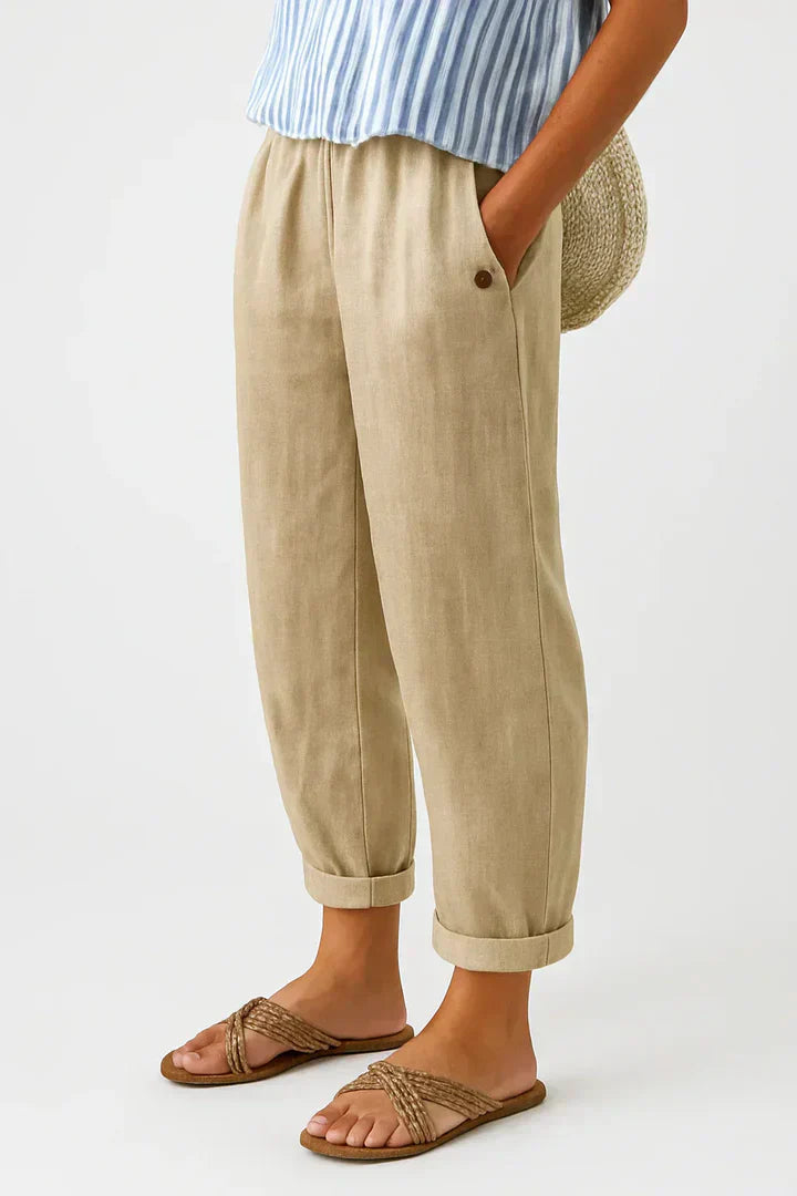 Women's relaxed fit trousers with elastic waistband, straight leg, & slip pockets for everyday comfort.