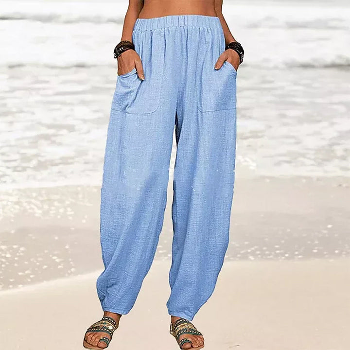 Folded Rizza women's travel pants, demonstrating their packability and suitability for vacation style.