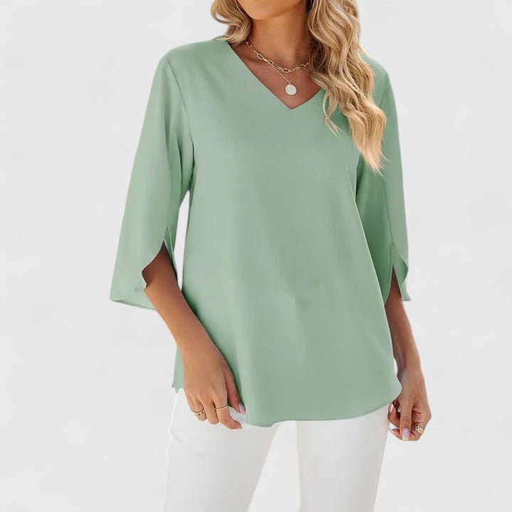 Effortless style women's top: V-neck, ruffles, and flowy split sleeves for a relaxed fit.