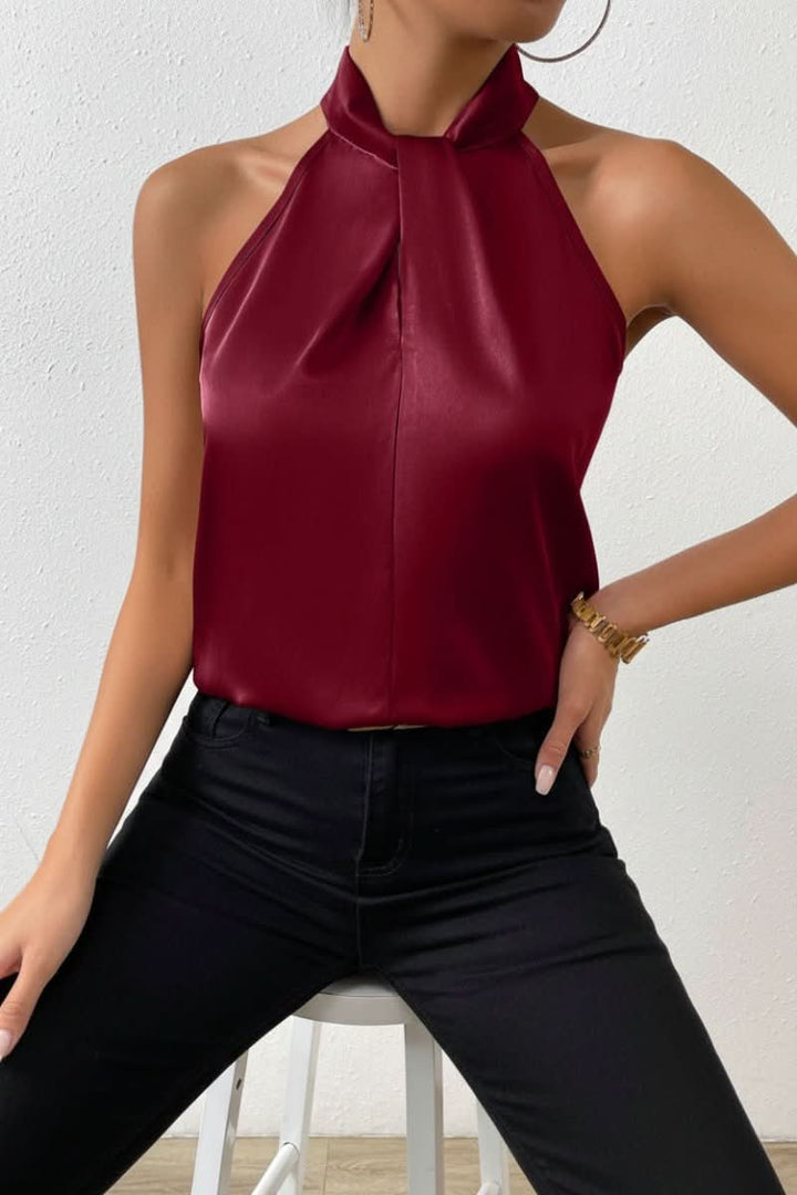 Sculpted women's sleeveless blouse with a modern halter knot detail, offering a flattering fit.