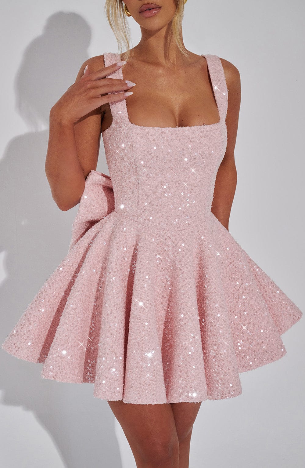 White sequined party dress for women, fit & flare style, short length, features a beautiful back bow.