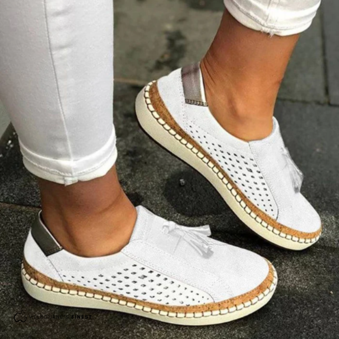 Versatile women's perforated slip-on loafers, perfect for everyday casual style. Features classic tassel detail.