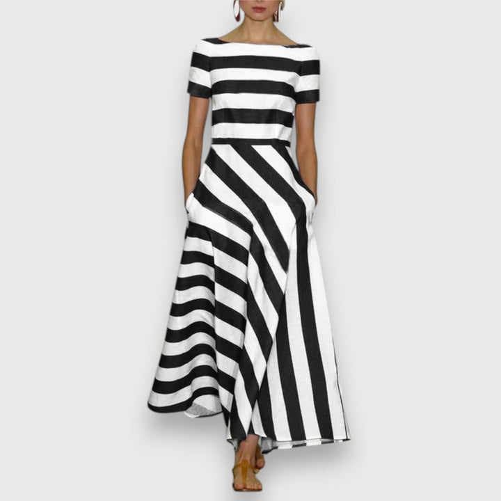 Chic women's striped boat neck midi dress, an A-line silhouette with essential pockets for comfortable spring fashion.