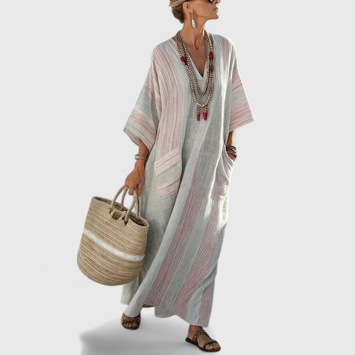 Full-length women's striped maxi dress, V-neck, sleeveless, with hidden pockets for a stylish, practical summer outfit.