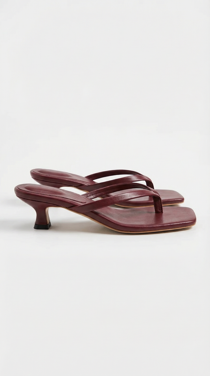 Dressy women's slip-on sandals with a subtle kitten heel and thong strap.