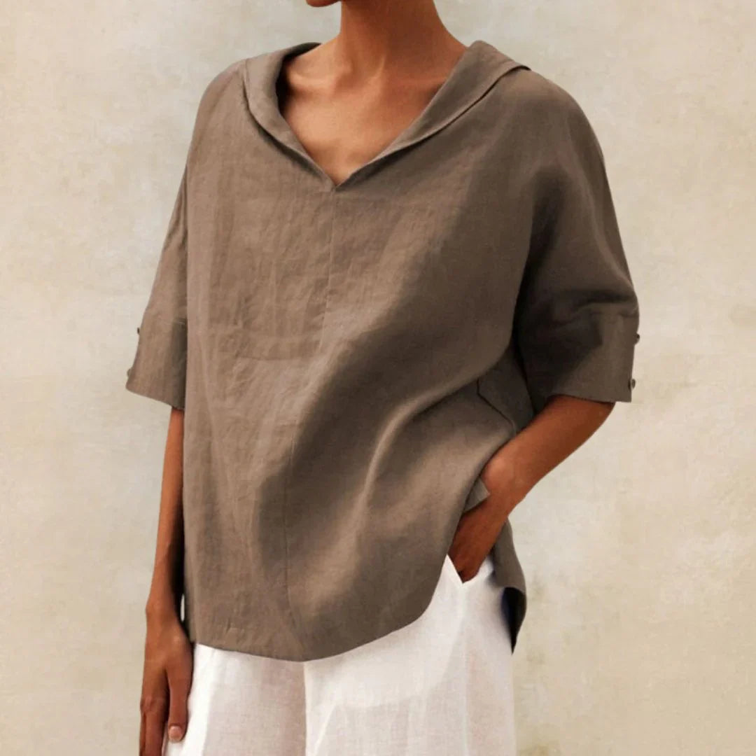 Stylish women's summer top with practical roll-up sleeves and a classic button front, offering a relaxed fit.