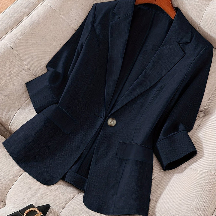 Stylish model in a crisp tailored cropped blazer with a skirt for business chic.
